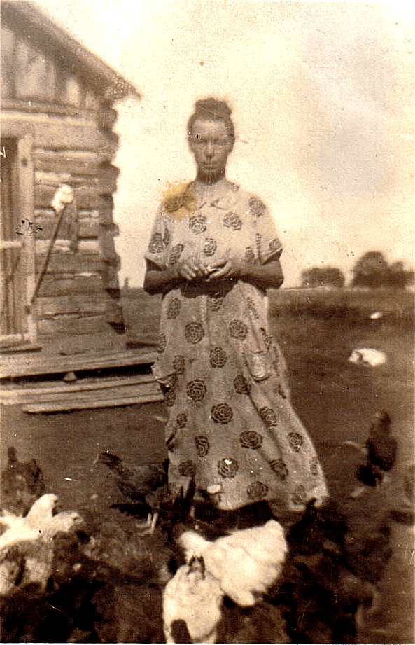 Pioneer woman at log cabin